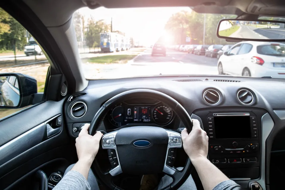 View from inside car's driver seat while driving.